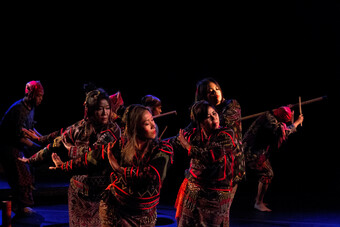photograph of posaka dancers performing on stage.