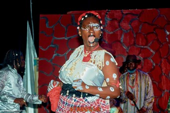 An actress sings passionately during a performance.
