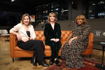 The authors of this article sit on a leather couch backstage.