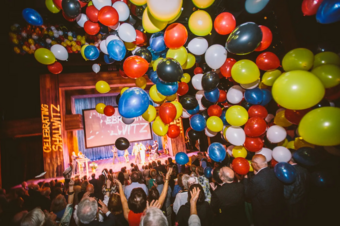 Colorful balloons flying in the air of a theater. 