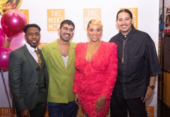 Four people posing together for a photo.