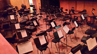 a room full of chairs and music stands