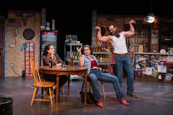 Three actors at a kitchen table in a dining room set on stage.