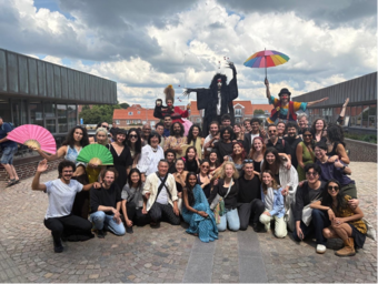 A group of people pose for a photo outdoors.