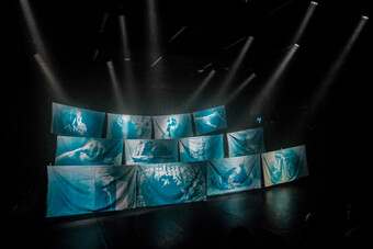 A set of sheets with projections onstage.