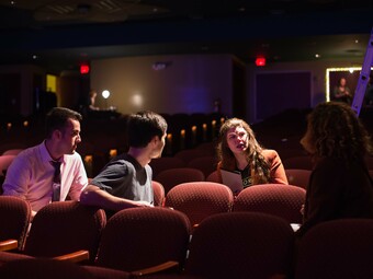 three people in a theatre