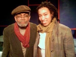 An old black man and a young black woman posing together for a photo.