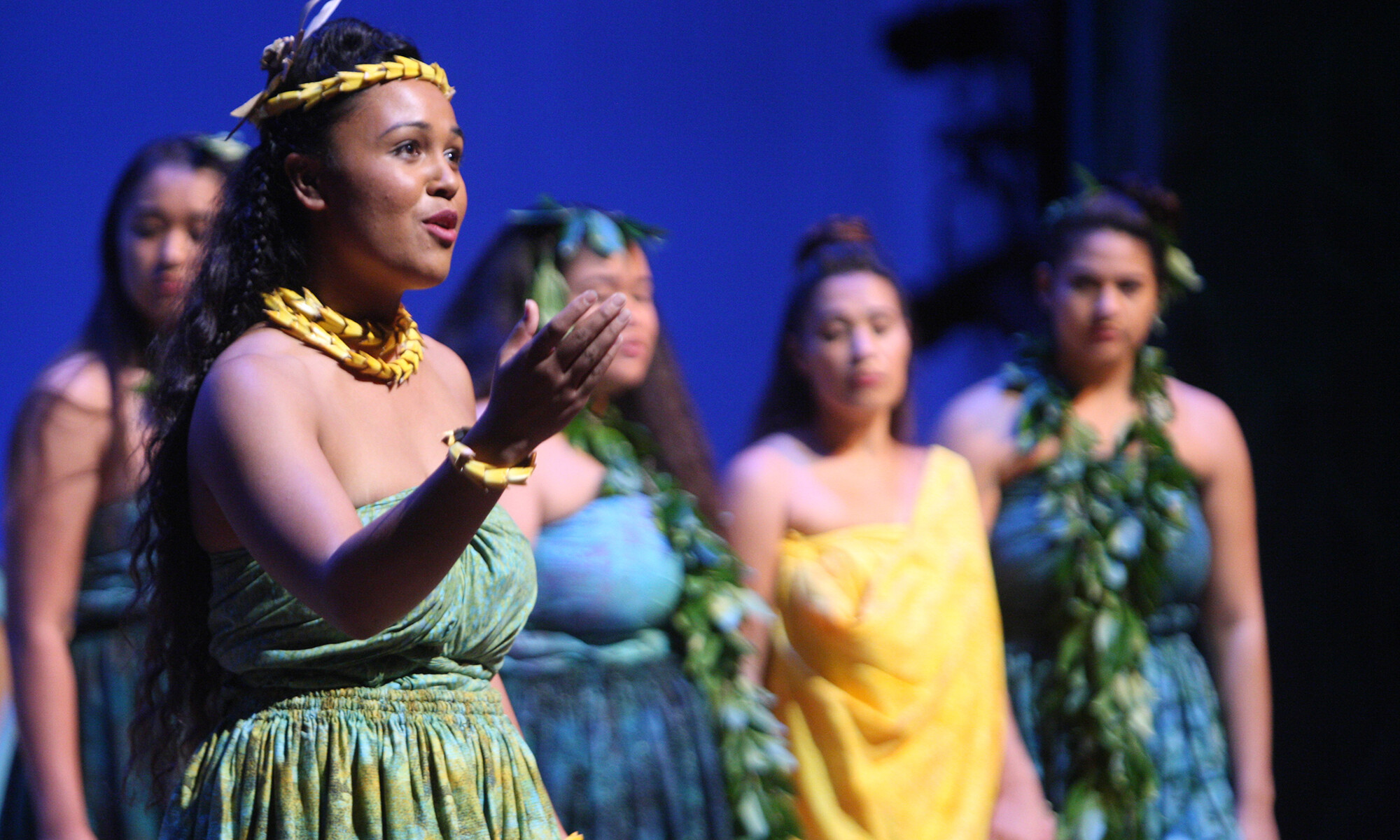 group of Hawaiian performers singing onstage