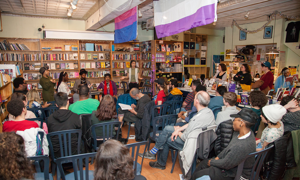 a large group seated in a bookstore