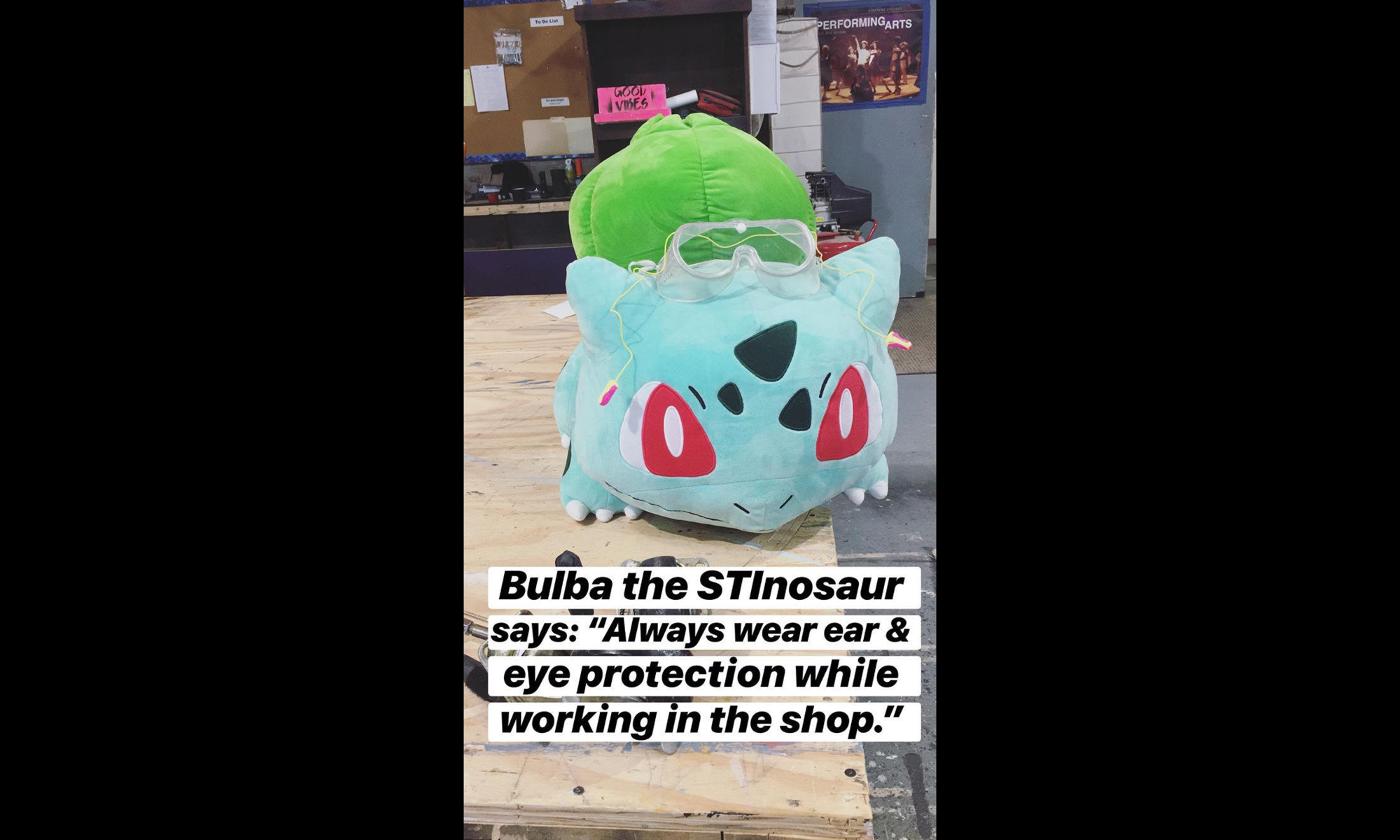 photo of a stuffed bulbasaur with the caption "Bulba the STInosaur says: 'Always wear ear & eye protection while working in the shop.'"