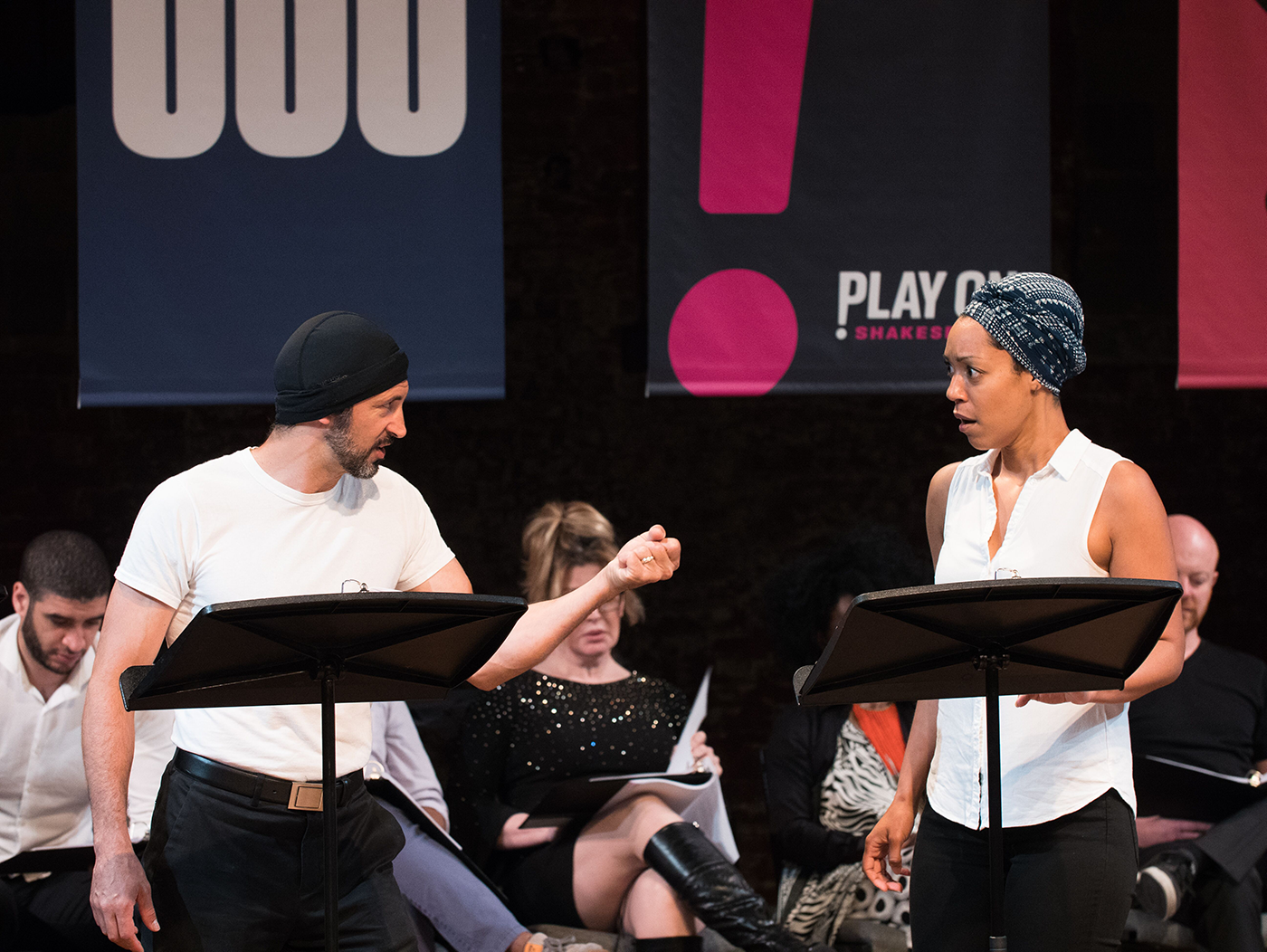 two actors performing in a staged reading