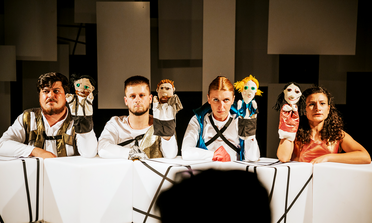 four actors with hand puppets onstage