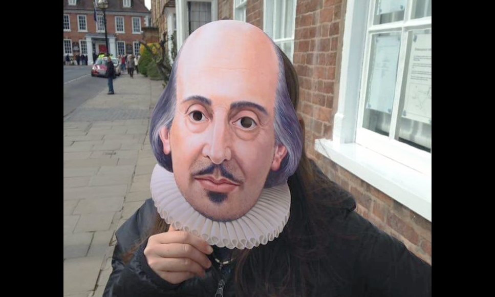 madeline sayet holding a paper shakespeare mask