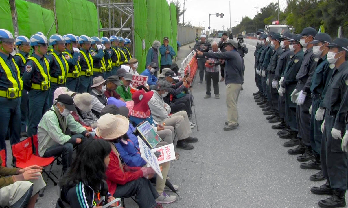 okinawa protestors on the left and police on the right