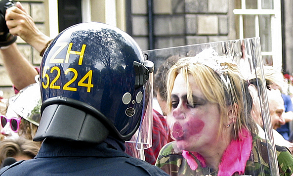 a clown kissing a clear riot shield
