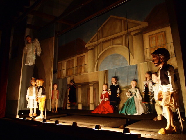 A picture of a stage with puppets on it.