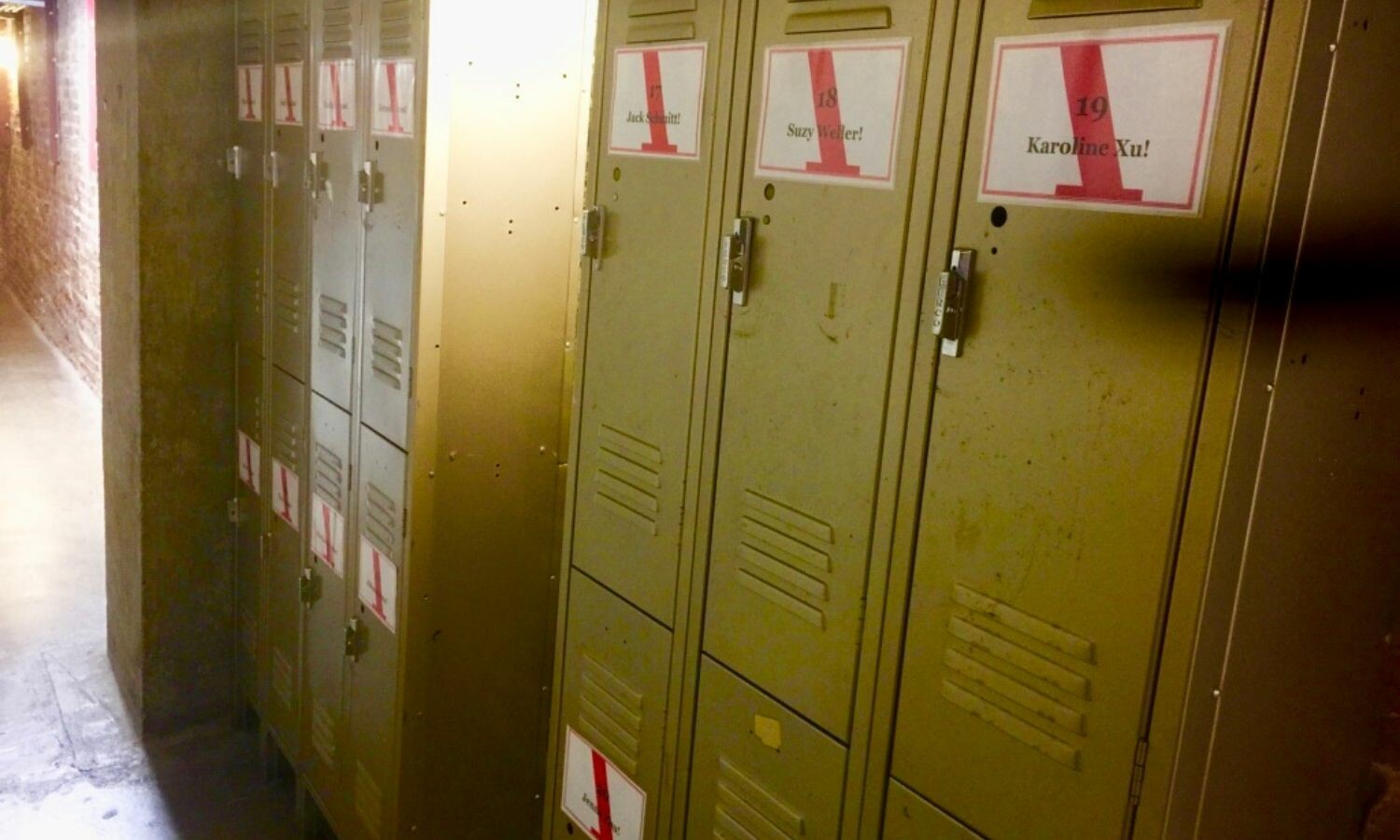 Seven sets of lockers with interns names taped on them.