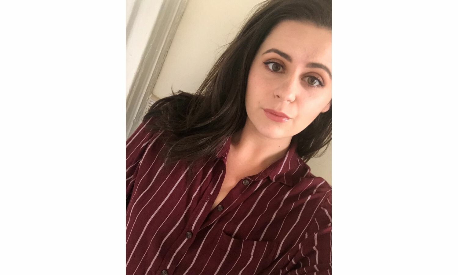 A selfie of Ashley Malafronte, wearing a red shirt with white stripes.