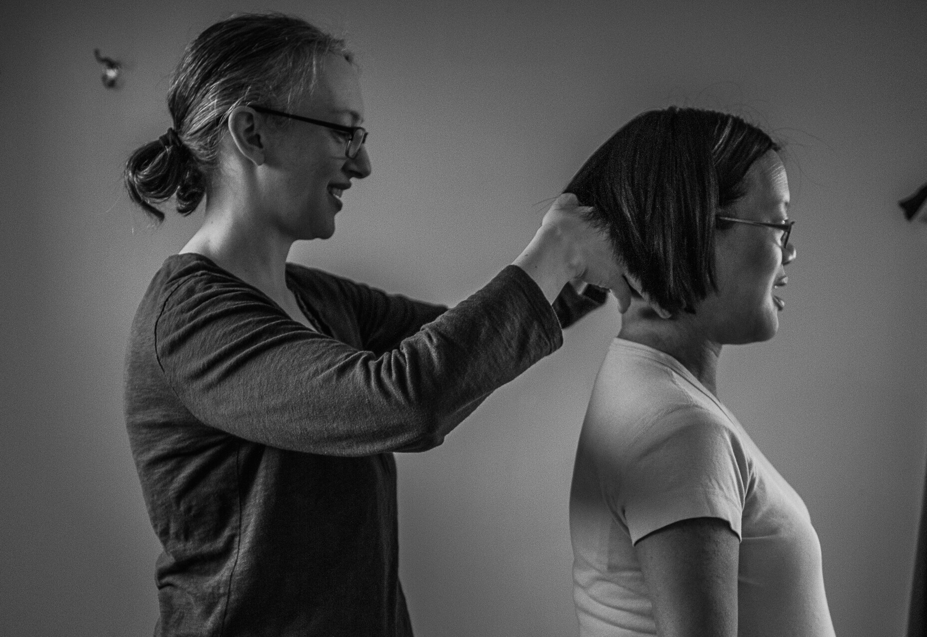 A woman cutting a girl's hair.