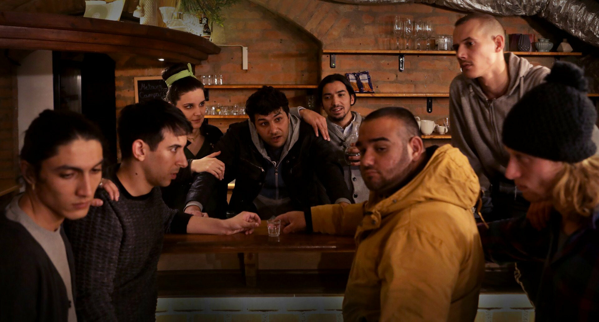 Seven people at a bar table.