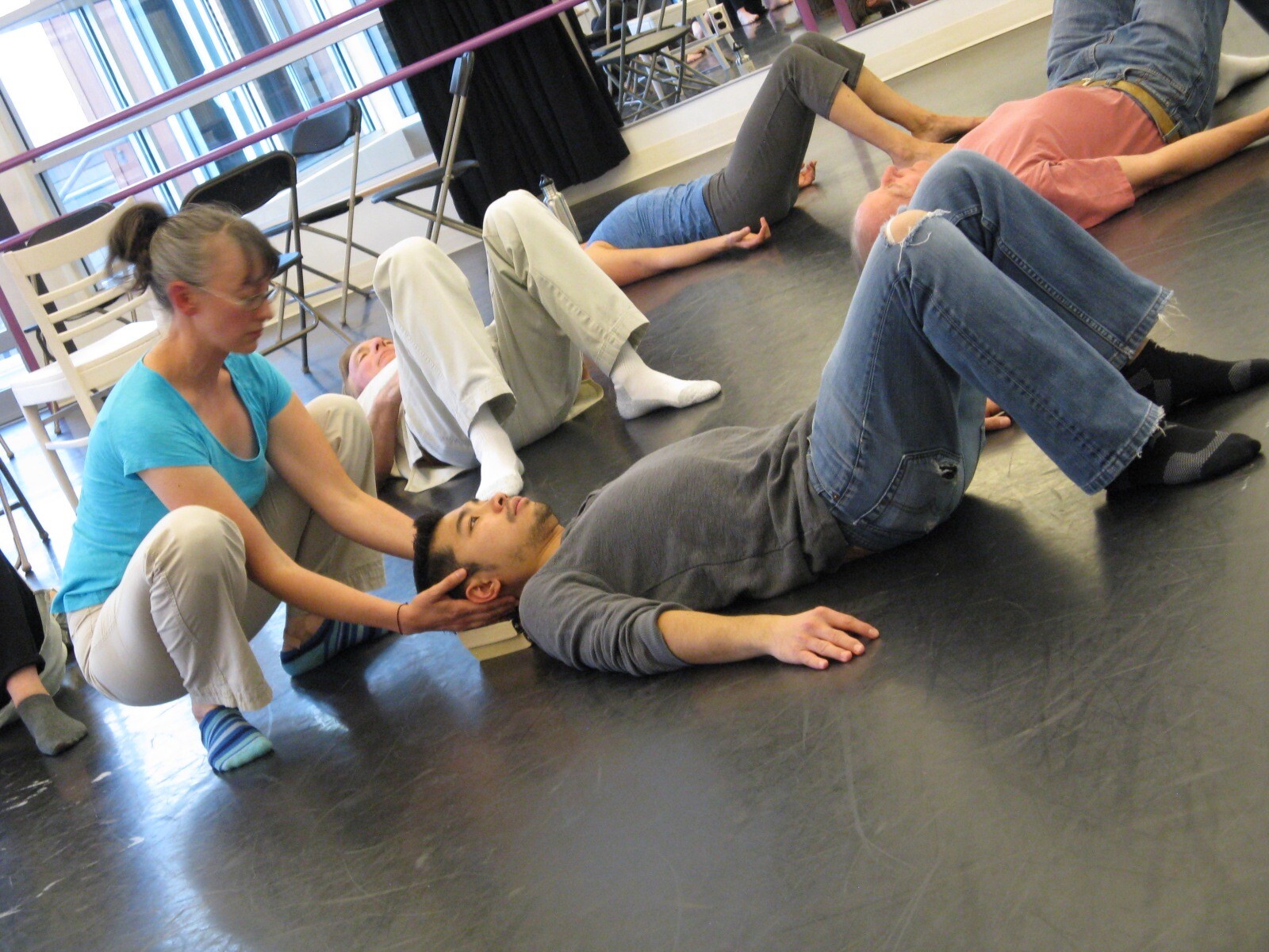 Two people doing an acting exercise on the floor.