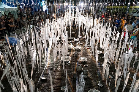 A series of suspended icicles hanging over a dinner table.