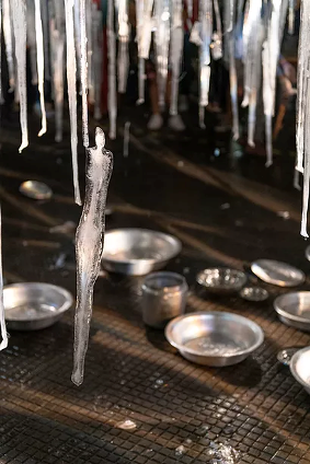A close up of suspended icicles hanging over a dinner table.