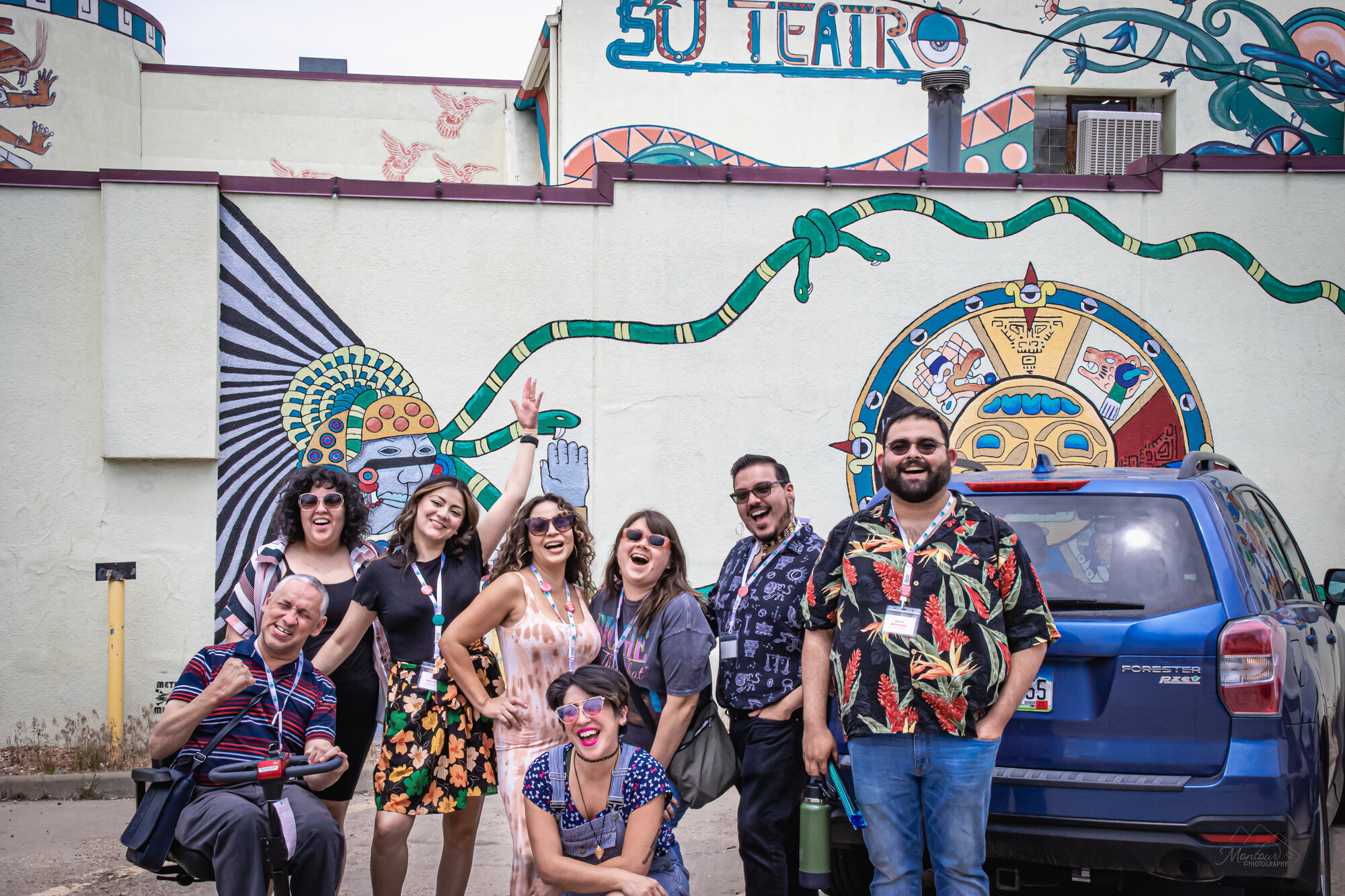 LTC attendees standing in front of a mural at Su Teatro.