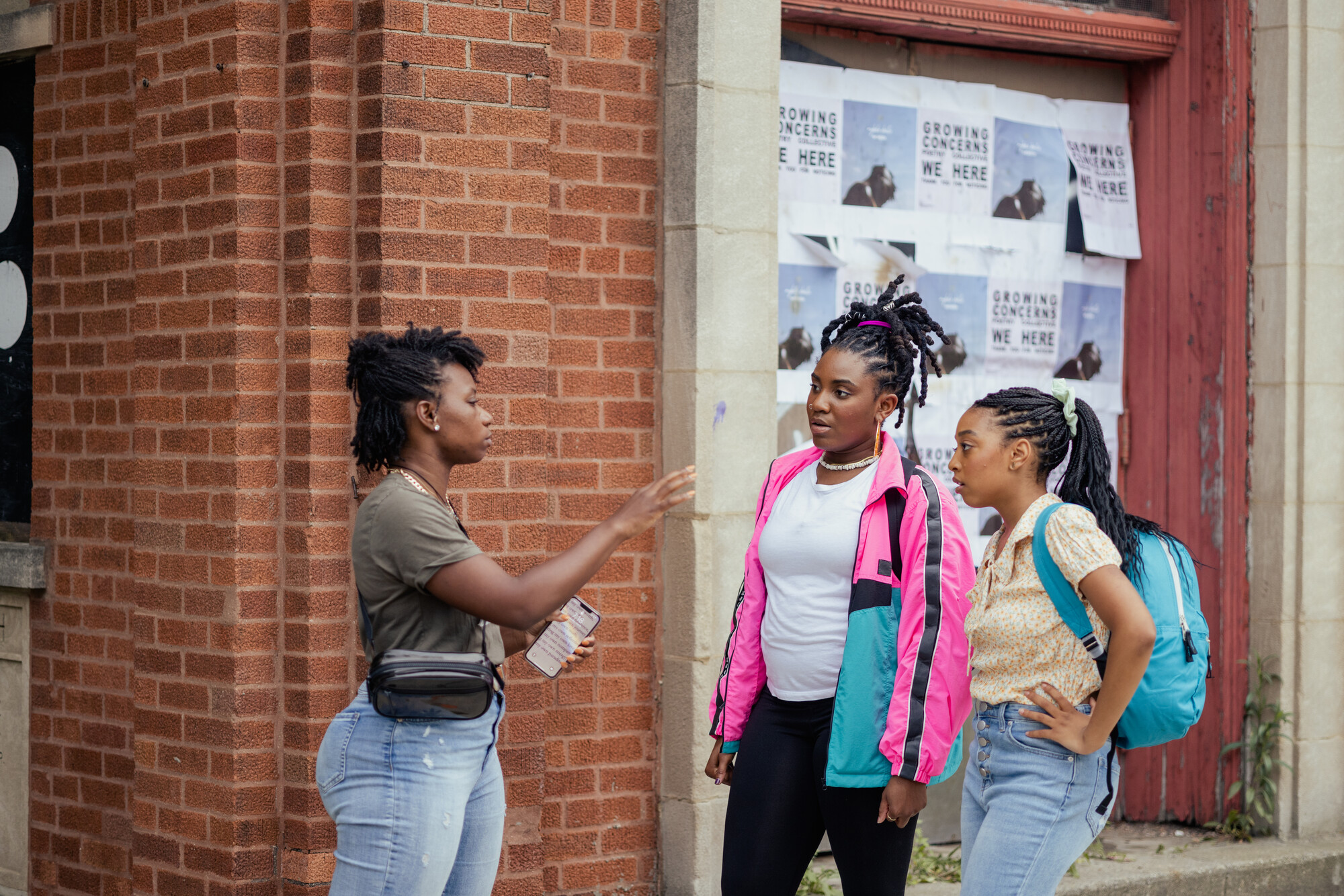 Three black women having a conversation.
