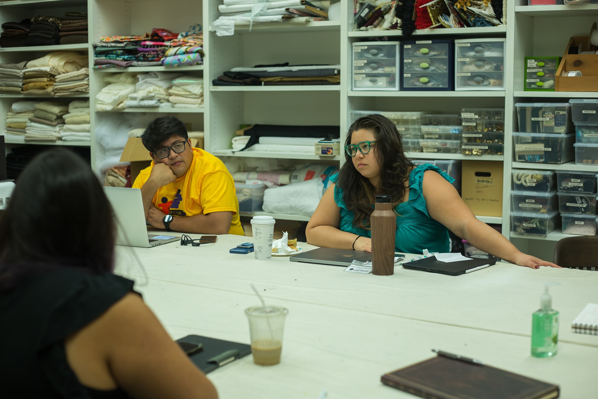 Two Colaboratorio participants listen intently during a session.