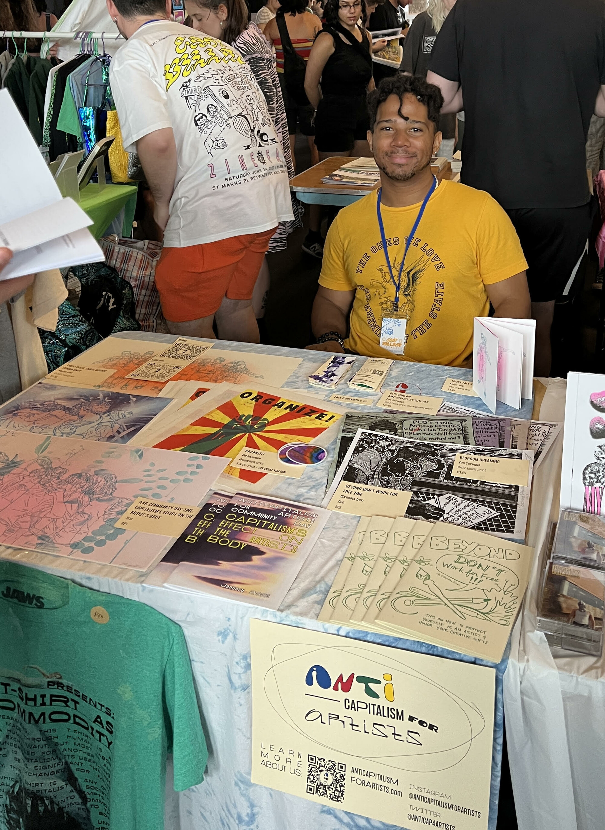 Chris Myers sits at a table at the East Village Zine fair.