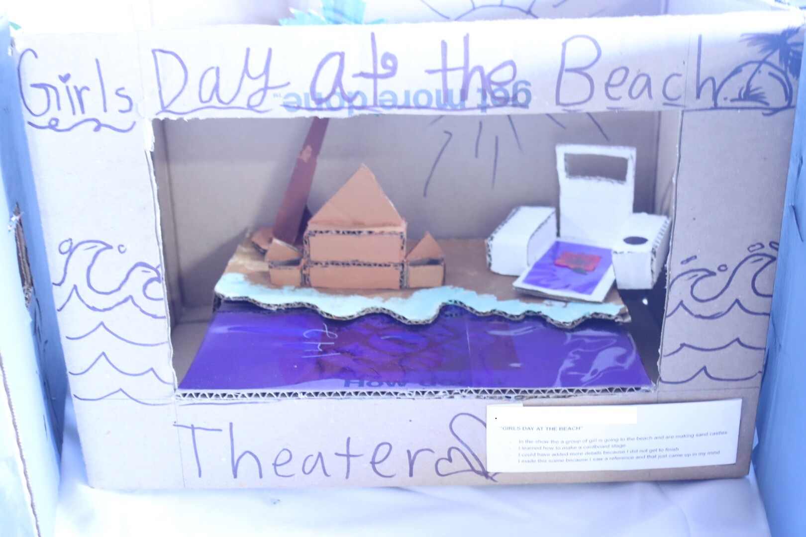 A model box showing a set design of a beach.