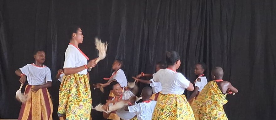 A group of students dance on stage.