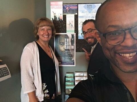 Ellen Lewis, Nate Cohen and Vin Shambry take a slefie in fornt a poster for The Gun Show.