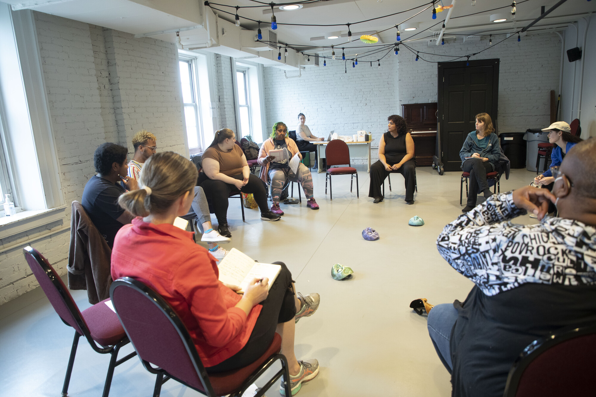 A group of people sit in a circle having a discussion.