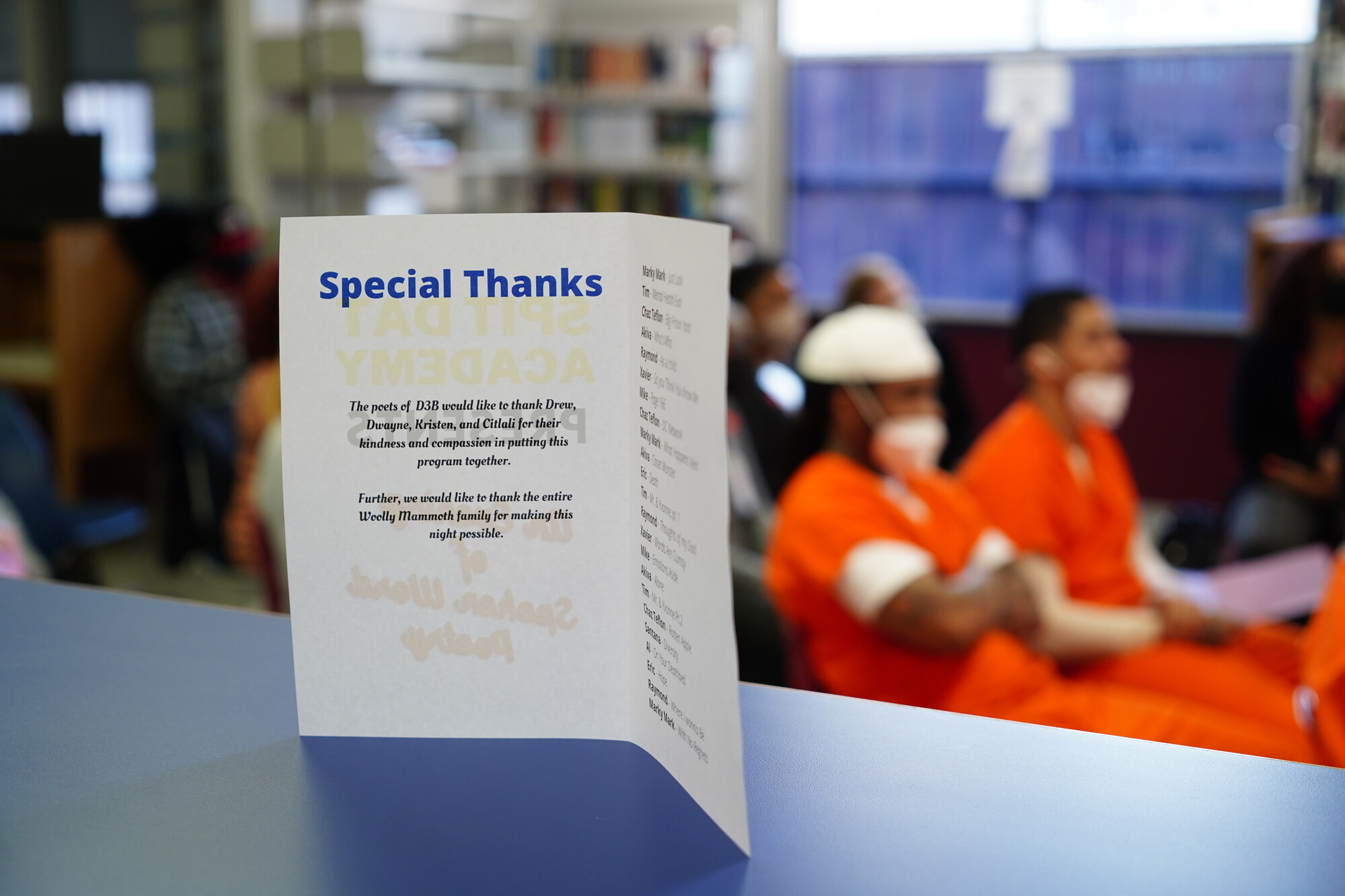 A image of a thank you note in font of audiences at a show at Spit Dat Academy.