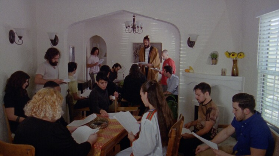 A group of people gathered in a living room. 