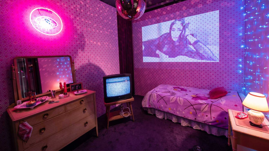 A bedroom in magenta light.