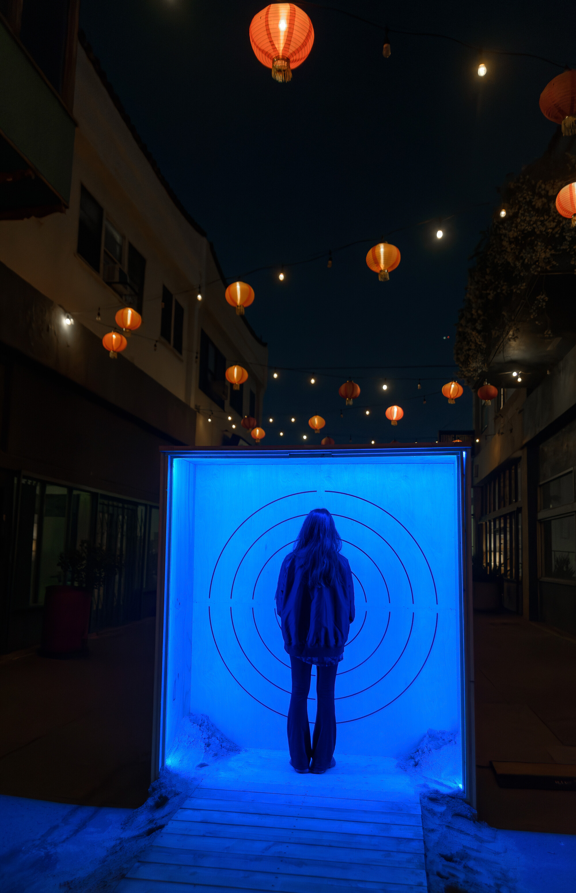 The silhouette of a person surrounded by blue light.