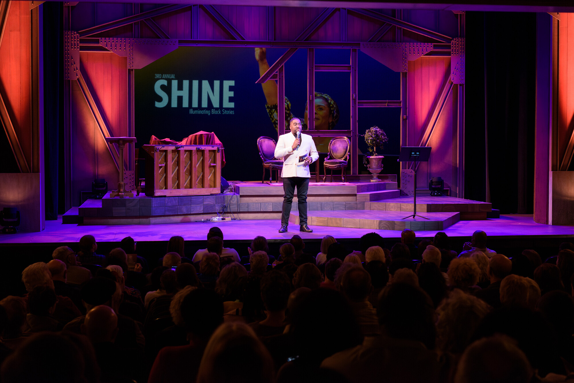 A person speaks alone on stage. 