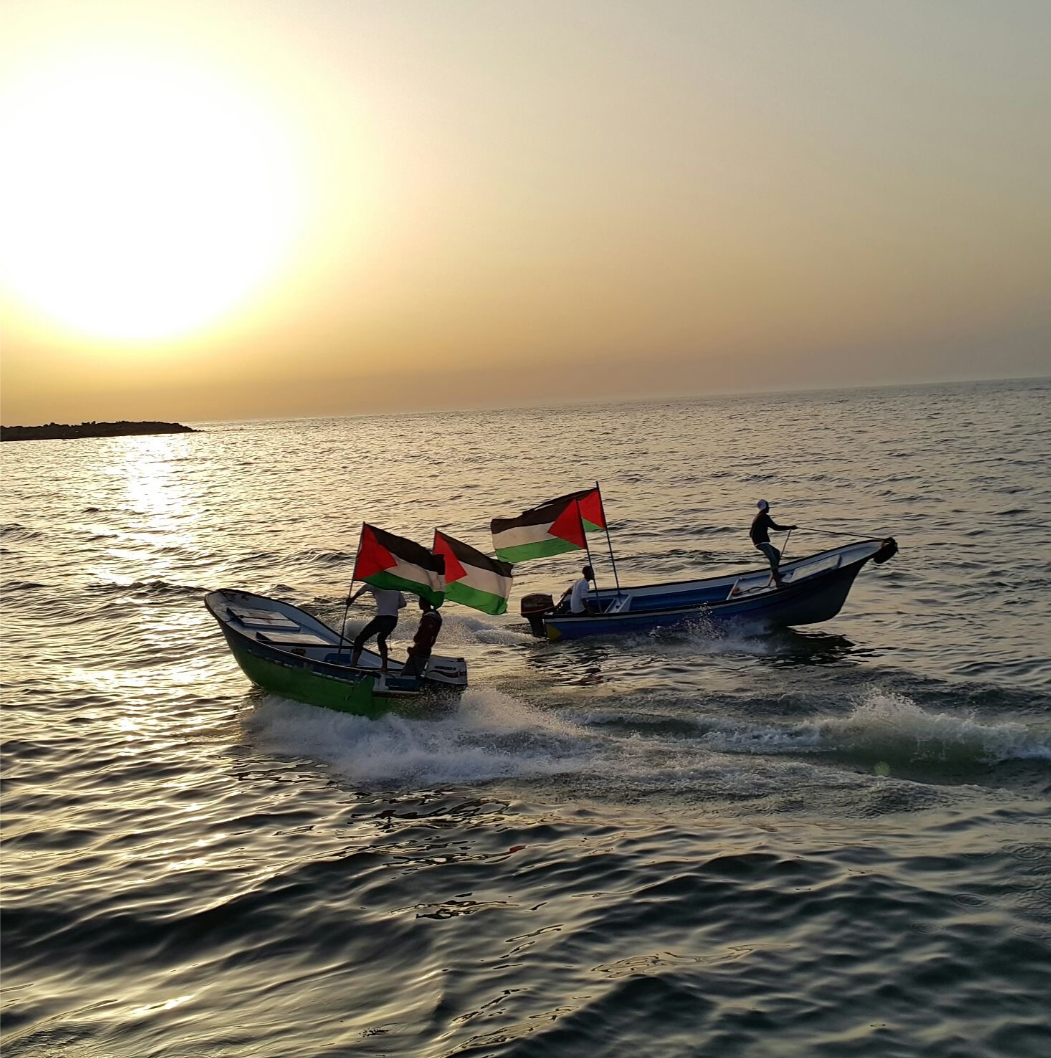 Boats on water with Palestinian flags. 
