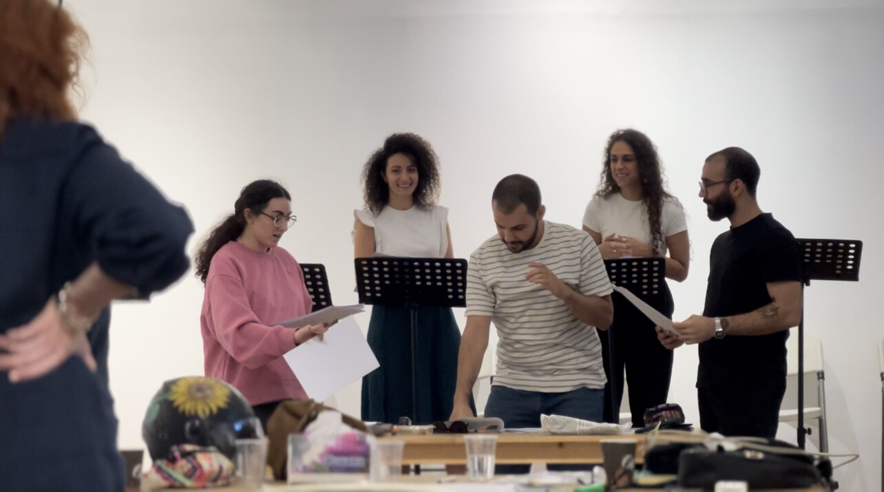 A group of people holding scripts.