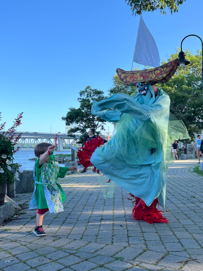 A child and an adult in costumes. 