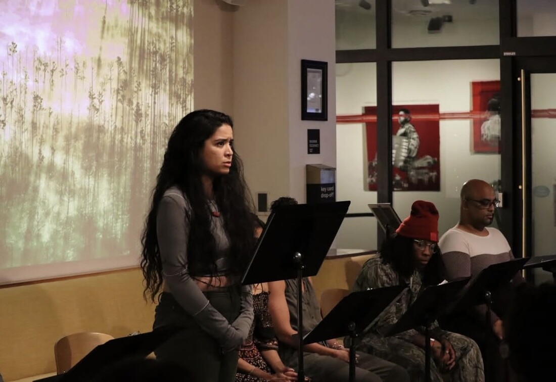 A woman behind a music stand with a confused expression on her face. 