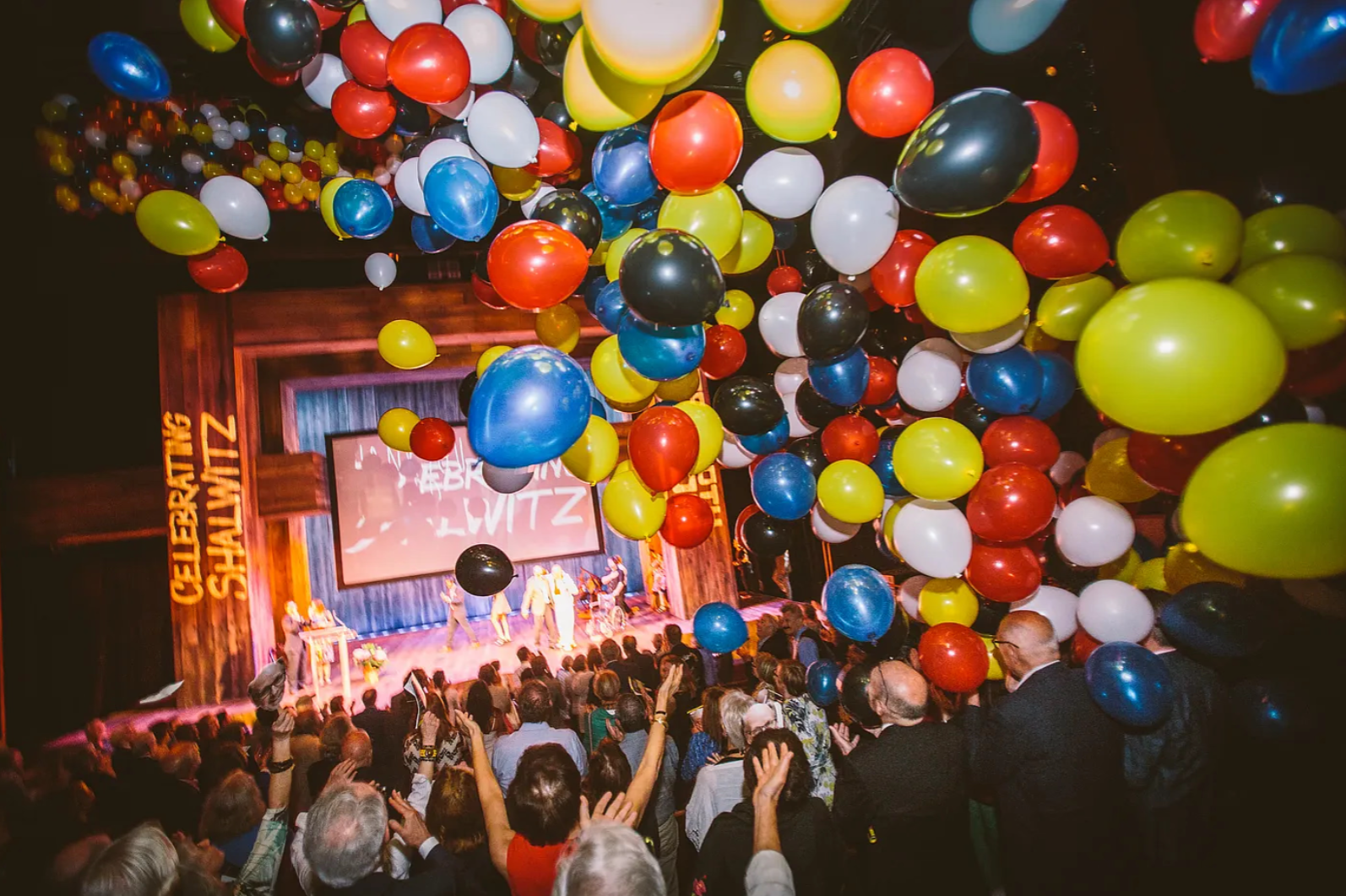 Colorful balloons flying in the air of a theater. 