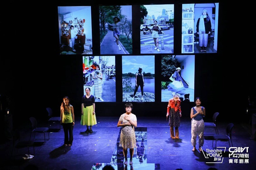 A couple of people on stage with various images projected behind them. 