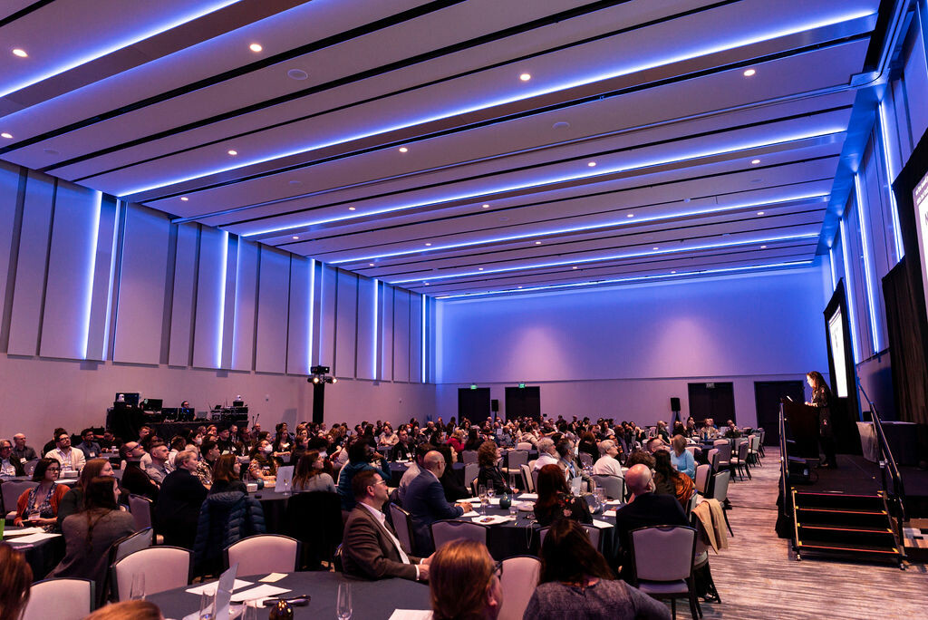 A large conference room full of people. 