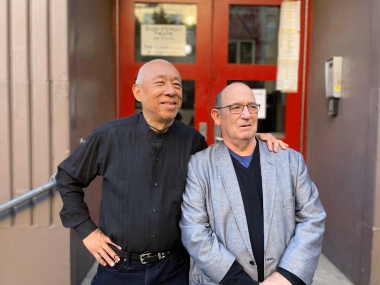 Two men standing next to each other.