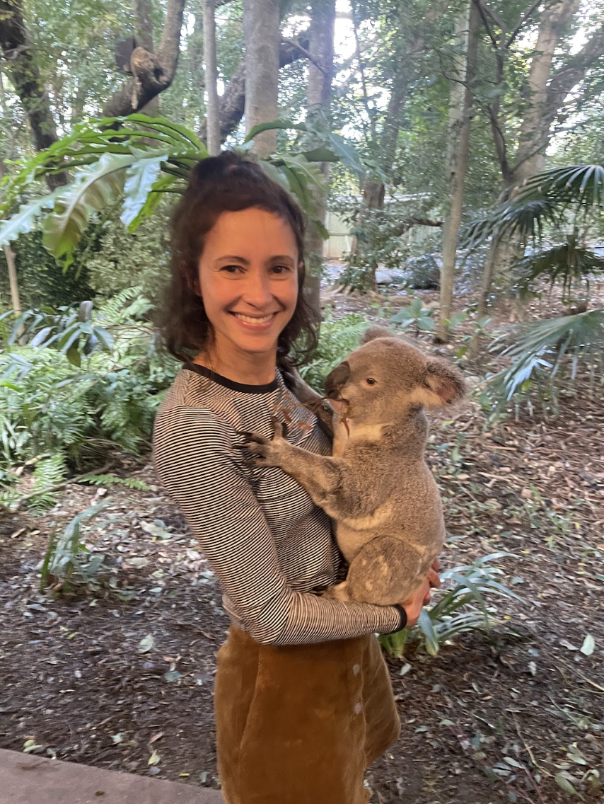 A woman holding a koala.