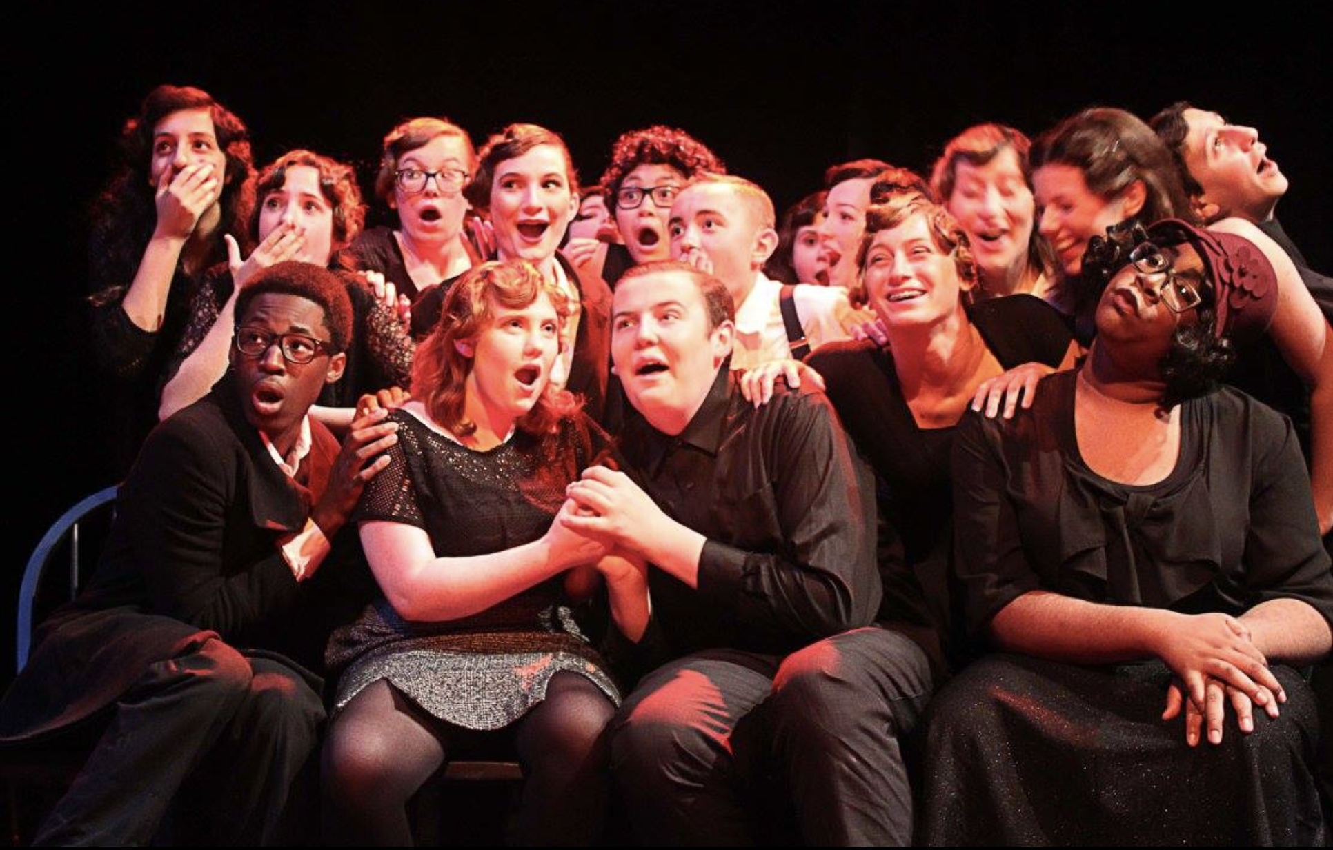 An ensemble of children gathered on stage.